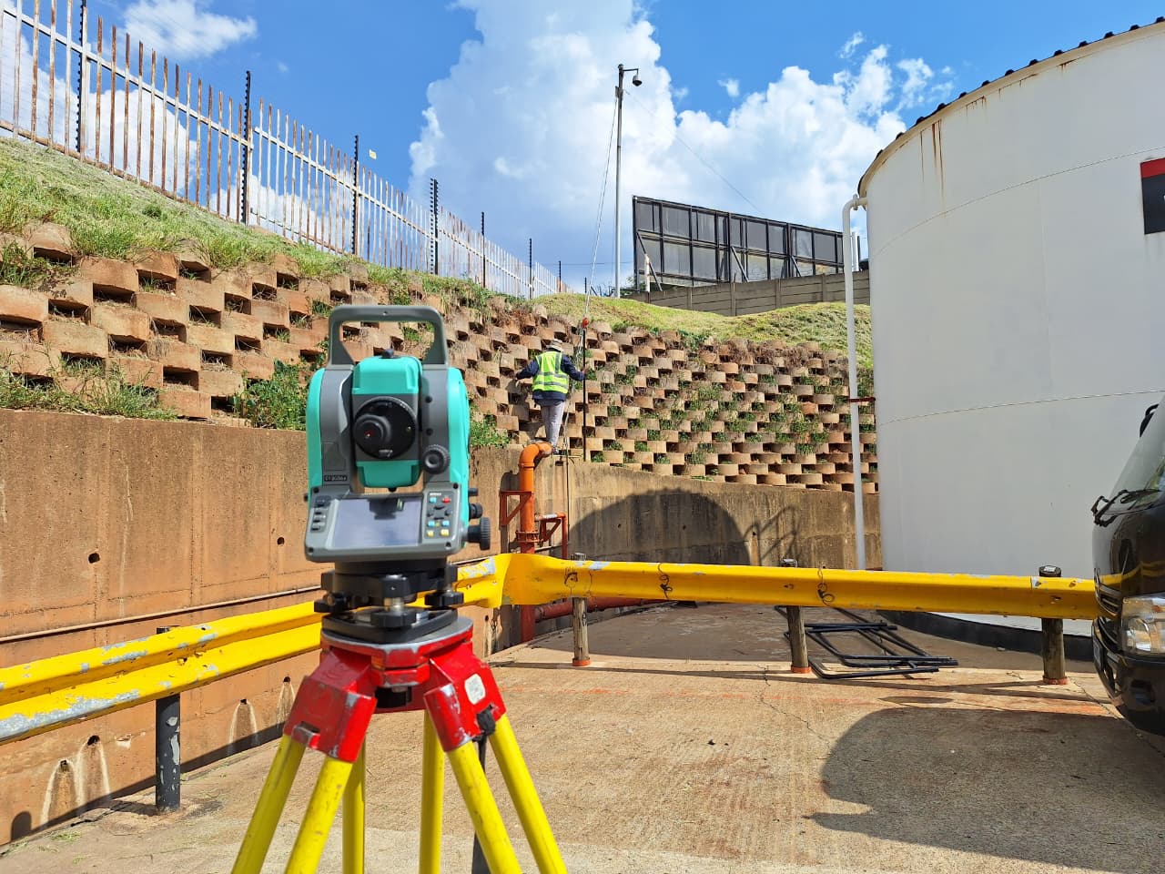 Land surveyor with GPS equipment in the field